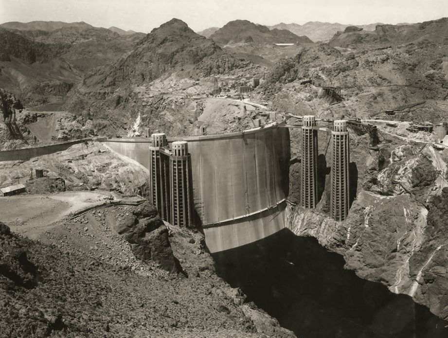 Boulder Dam rising across Black Canyon with its intake towers, nearing completion